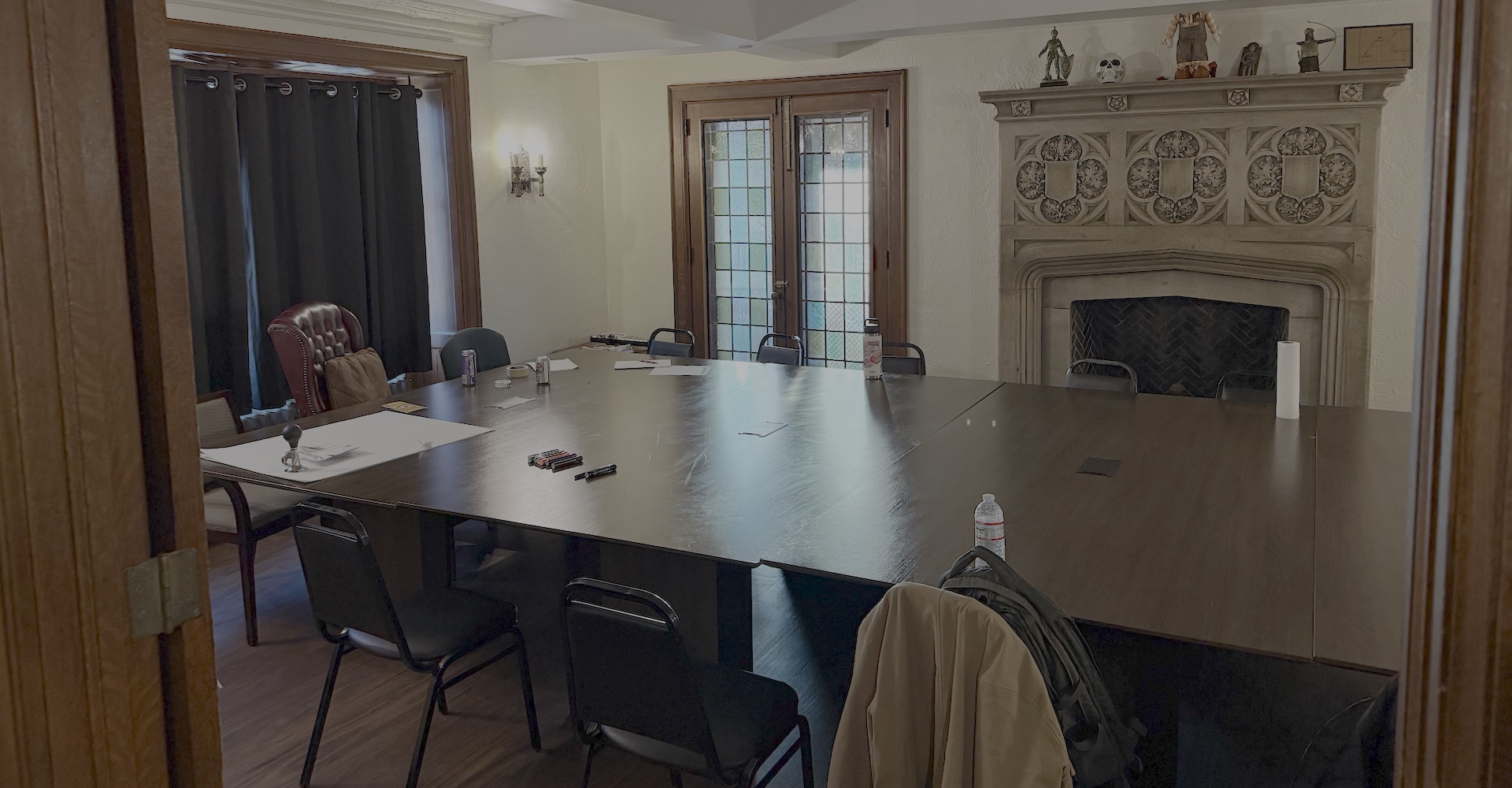 Chapter meeting room with large table and fireplace
