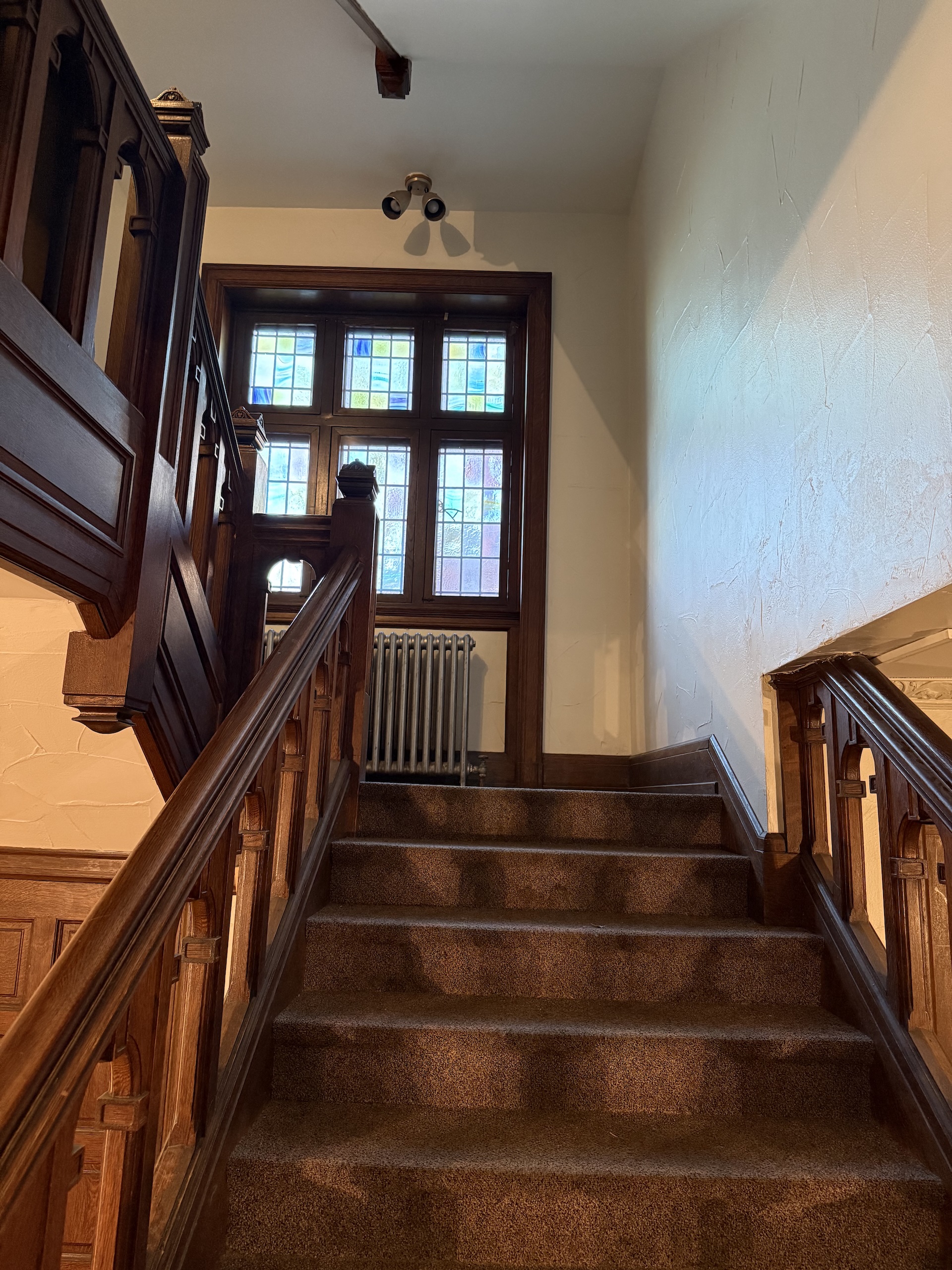 Grand staircase with stained glass window